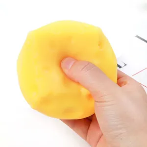 Detailed close-up showing a soft TPR simulation cheese squishy toy being squeezed