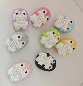Detailed view of colorful hand-crocheted positive energy penguins with cards