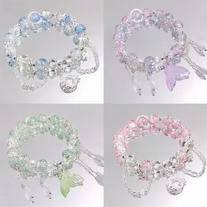 Detailed view of four colorful forest style moon crystal beaded bracelets in a set