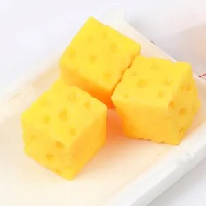 Detailed macro view of three yellow TPR cheese-shaped squeeze toys for stress relief