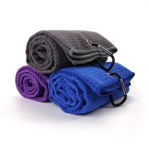 Detail view of waffle texture microfiber golf towels with durable black carabiners.