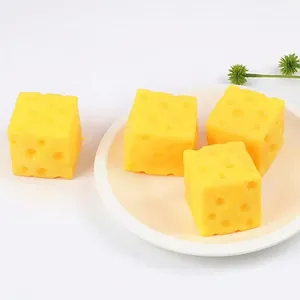 Four TPR squishy cheese-shaped stress relief toys on a white plate for sensory play