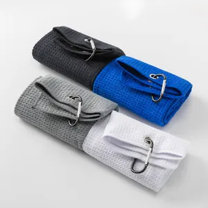 Close-up of four microfiber waffle golf towels in different colors with metal clips