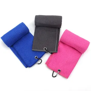 Close-up detail of microfiber waffle weave golf towels in blue, grey, and pink colors
