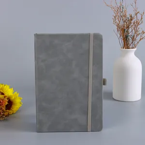 Elegantes graues A5 Notizbuch mit strukturierter Hülle und Gummiband auf dem Tisch