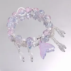 Close-up of a dreamy crystal beaded bracelet featuring a mermaid tail pendant charm