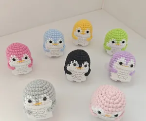 Set of colorful handmade crocheted positive penguins with tiny encouragement cards