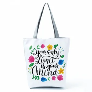 Detail of white floral tote bag with 'Your only Limit is your Mind' motivational print