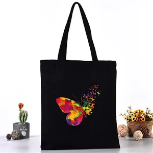 Durable black canvas tote bag featuring a vibrant colorful butterfly print for daily use