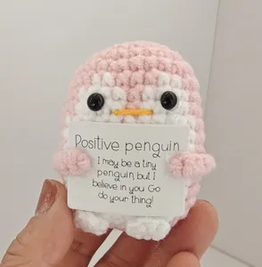 Handmade pink crochet penguin holding a positive message card encouragement gift
