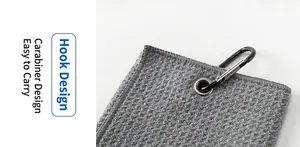 Close-up of microfiber golf towel with waffle texture and a sturdy black carabiner hook
