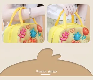 Detailed view of yellow insulated lunch bag featuring 3D cartoon pineapple and flower patterns