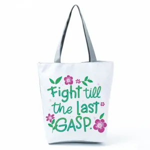 Close-up detail showing the vibrant floral print and inspirational quote on white tote bag