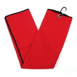 Red microfiber waffle weave golf towel with metal grommet and black carabiner clip