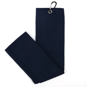 Navy blue microfiber golf towel with waffle texture and black carabiner clip detail.