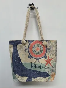 Close-up detail of nautical whale print and cotton rope handles on canvas beach bag