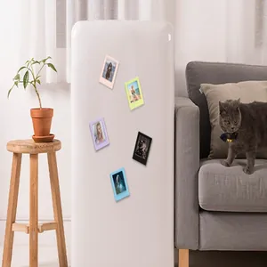 Detailed lifestyle view showing colorful 3-inch magnetic photo frames on a white refrigerator.