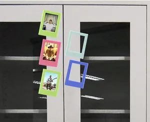 Colorful 3-inch magnetic photo frames for Polaroid displayed on a grey metal cabinet door