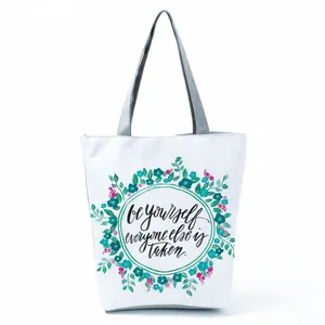 White floral print canvas tote bag featuring motivational quote be yourself design