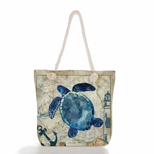 Close-up detail of sea turtle and anchor print on vintage map background beach tote bag
