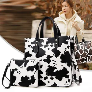 Fashionable cow print two-piece handbag set including tote bag and matching pouch