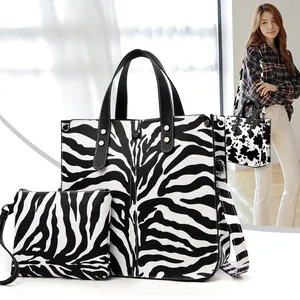 Zebra print fashion tote and pouch 2-piece set with model showing cow print variant