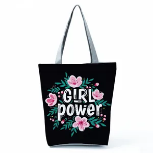 Stylish black canvas tote bag featuring floral patterns and Girl Power slogan print