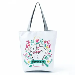 White canvas tote bag featuring a floral feminism power fist illustration print