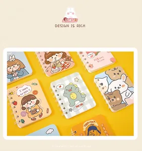 Set of A7 mini spiral notebooks with diverse cute cartoon covers on yellow background