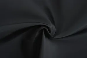 Macro detail shot showing the smooth and durable texture of the black jacket fabric.