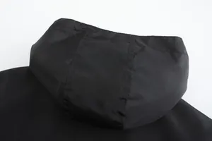 Close-up of the black hood and stitching on this men's casual outdoor jacket top.