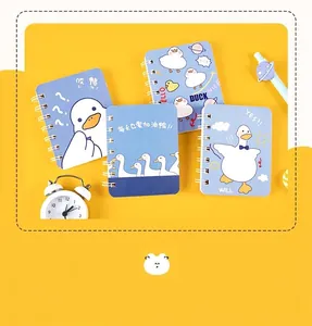 Detailed view of four A7 mini spiral notebooks featuring cute cartoon duck cover designs