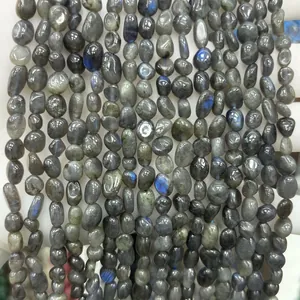 Close-up macro view of 6-8mm natural labradorite stone irregular chips with blue flashes