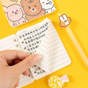 Compact A7 side-flip spiral notebook with cute animal-themed stationery props on yellow