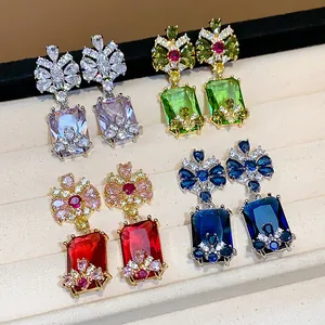 Detail of vintage palace style earrings with large colorful square zircons