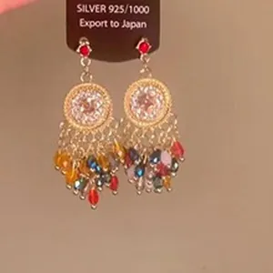 Close-up of vintage ethnic tassel earrings with colorful crystal water drop beads