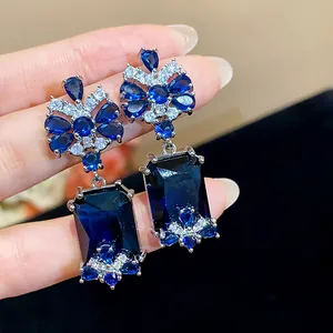 Elegant palace style silver earrings with blue rectangular zircon and floral detailing