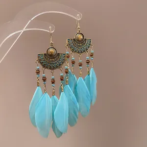 Bohemian vintage ethnic feather drop earrings with turquoise beads and bronze fan detail
