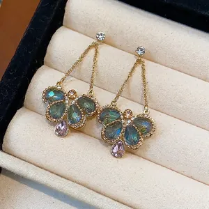 Exquisite gold-toned butterfly dangle earrings with blue and pink glass teardrops
