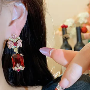 Close-up of elegant red square zircon drop earrings in palace style for women