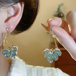 Elegant light blue glass butterfly drop earrings with gold finish and silver needles