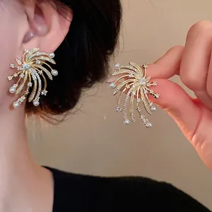 Elegant gold firework stud earrings with sparkling zircons and pearls for stylish women