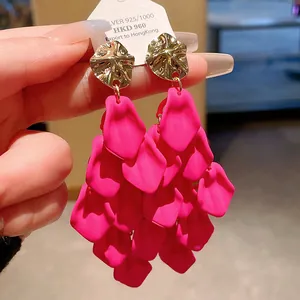 Macro detail of fuchsia petal tassel earrings with 925 silver needle and gold studs