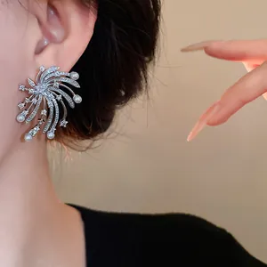 Detailed macro shot of silver firework stud earring featuring sparkling zirconia and pearls