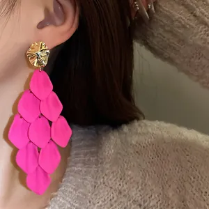Stunning close-up view of vibrant pink tiered petal tassel earrings with gold accents