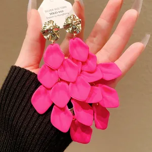 Detailed macro view of vibrant pink petal tassel earrings with metallic silver accents