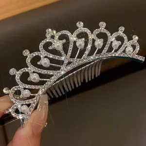 Close-up of sparkling rhinestone tiara with elegant white pearls and hair comb detail