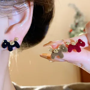 Close-up of vintage flocked horse stud earrings with elegant gold accents