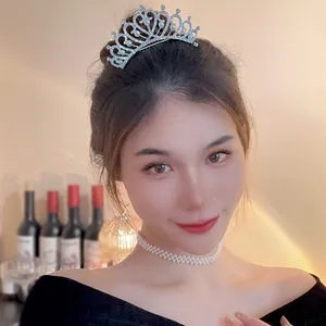 Elegant silver pearl and rhinestone bridal tiara crown worn by a model for parties