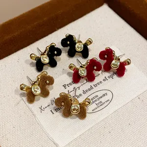 Detailed view of retro flocked pony earrings in black, red, and brown on a display card.
